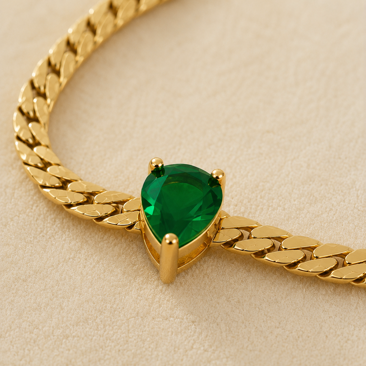 Maison Élyséa Émeraude gold necklace and bracelet set featuring emerald green pear-cut stones in waterproof PVD stainless steel