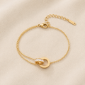 Maison Élyséa Amélie gold bracelet featuring Roman numeral circle charms and sparkling white zircon stones