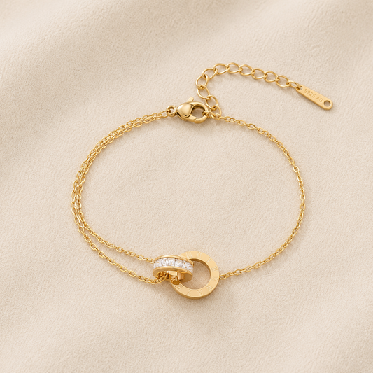 Maison Élyséa Amélie gold bracelet featuring Roman numeral circle charms and sparkling white zircon stones