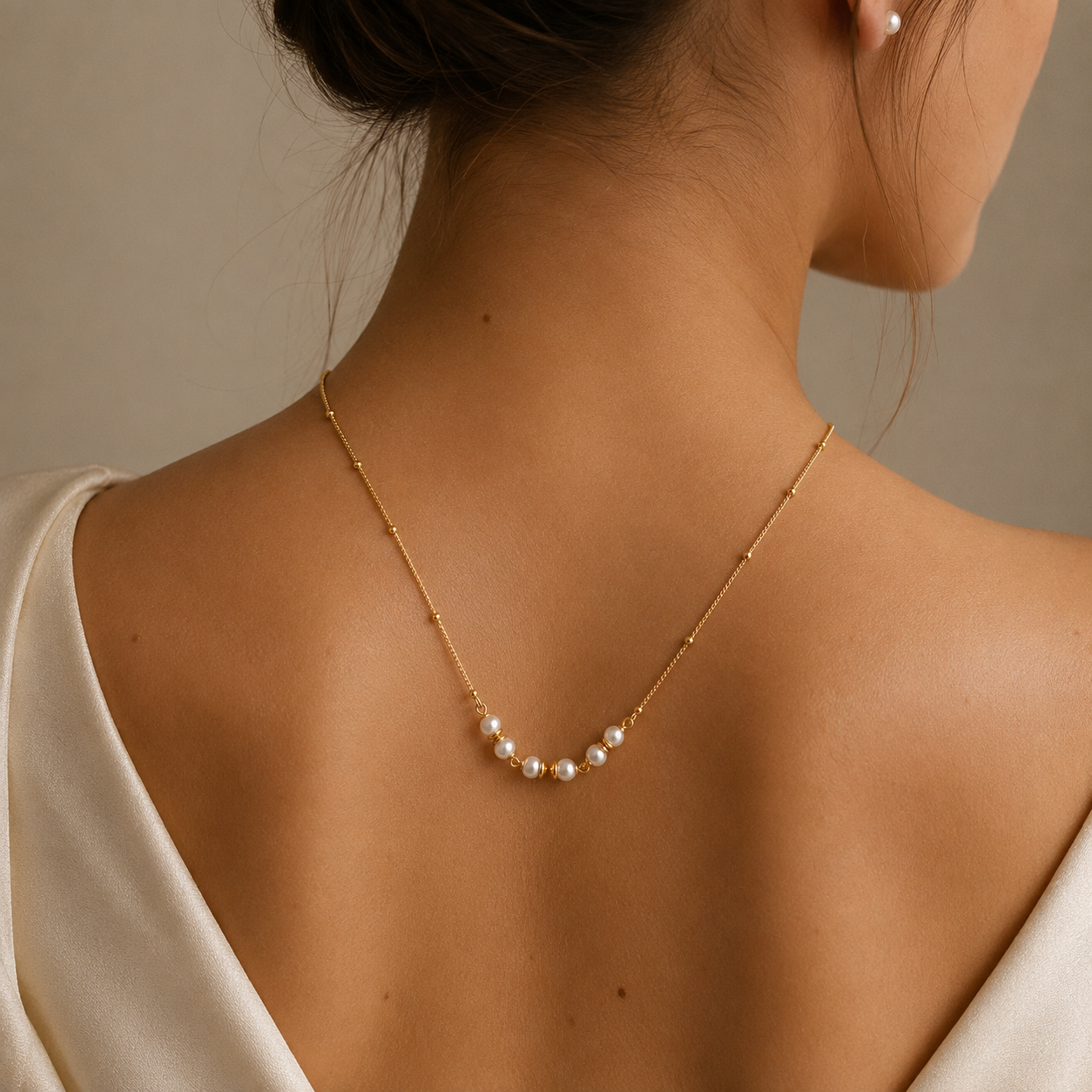 Model wearing the Anasa Pearl Gold Necklace featuring elegant pearl detailing on a waterproof 18K gold PVD stainless steel chain.