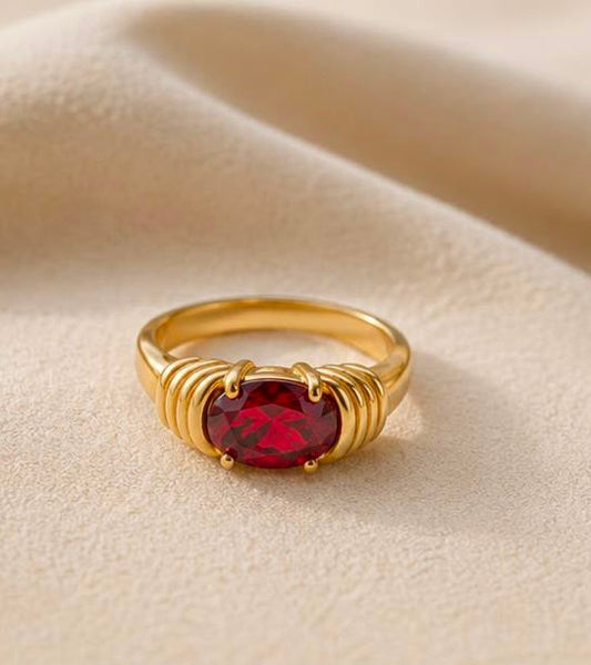 Maison Élyséa Naomi gold ring featuring a vibrant red zircon centre stone in a waterproof PVD stainless steel setting